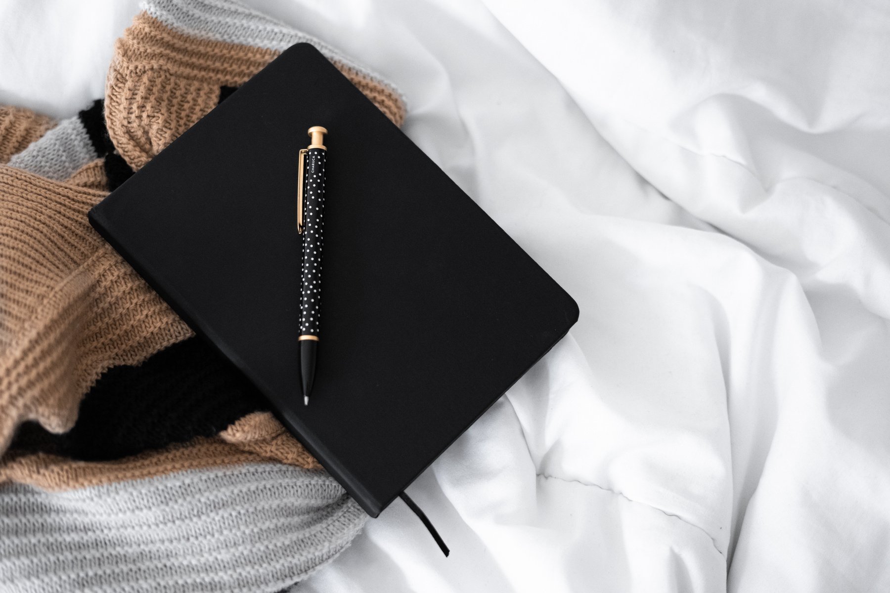 Scarf and Journal on Bed