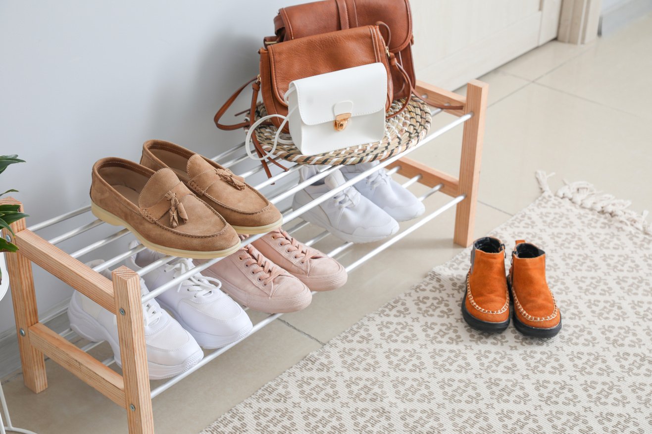 Stand with Stylish Shoes in Interior of Modern Hall